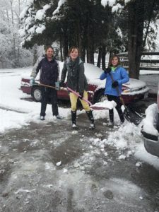 girls shovel snow